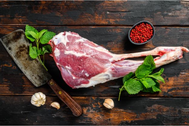 Buy Fresh Mutton Leg cut - Whole Raw Leg of Goat. Fresh Organic Meat on dark wooden background